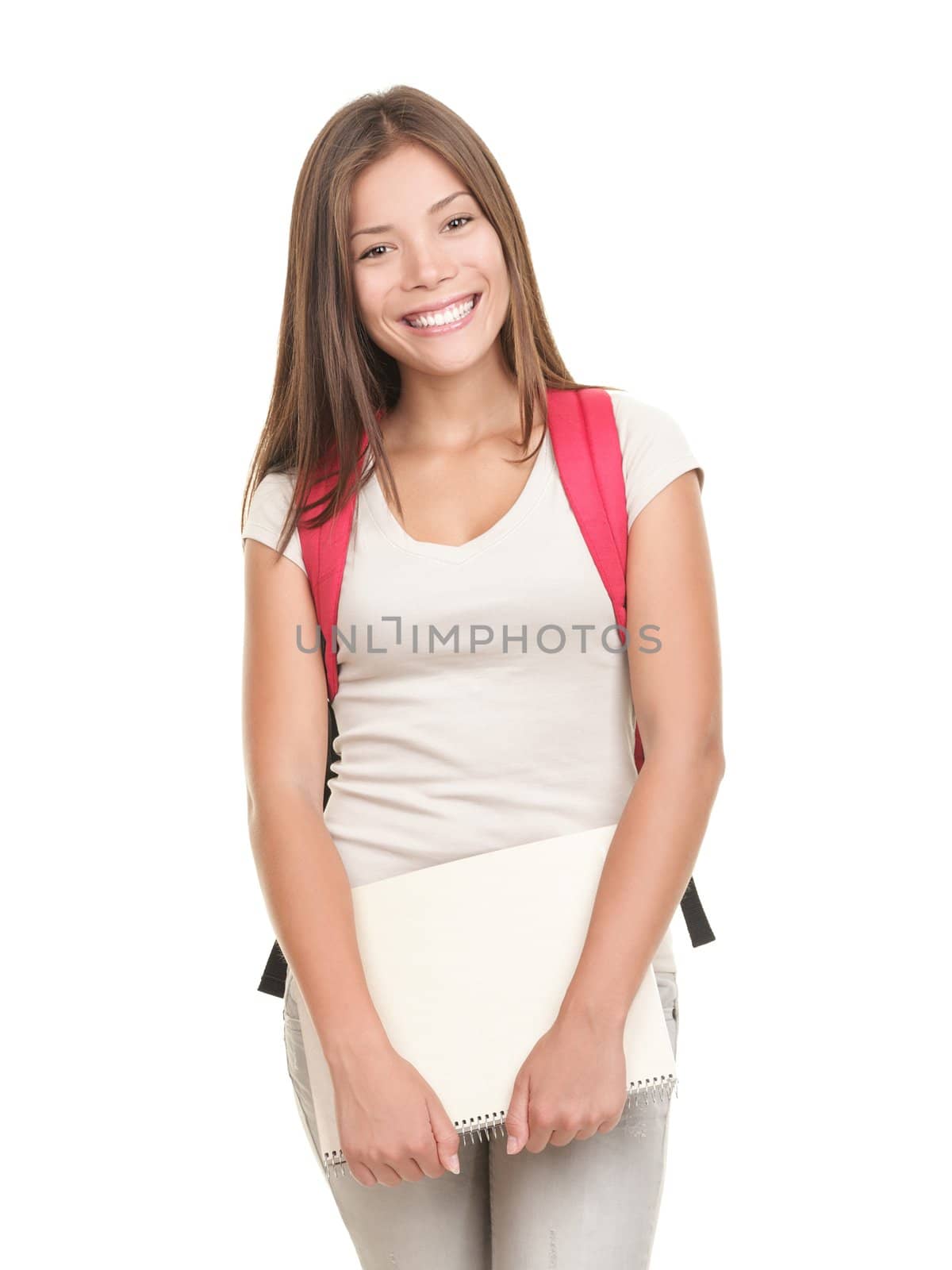Student. Female college university student isolated on white background. Smiling friendly to the camera, wearing a red school bag and holding note books. 
