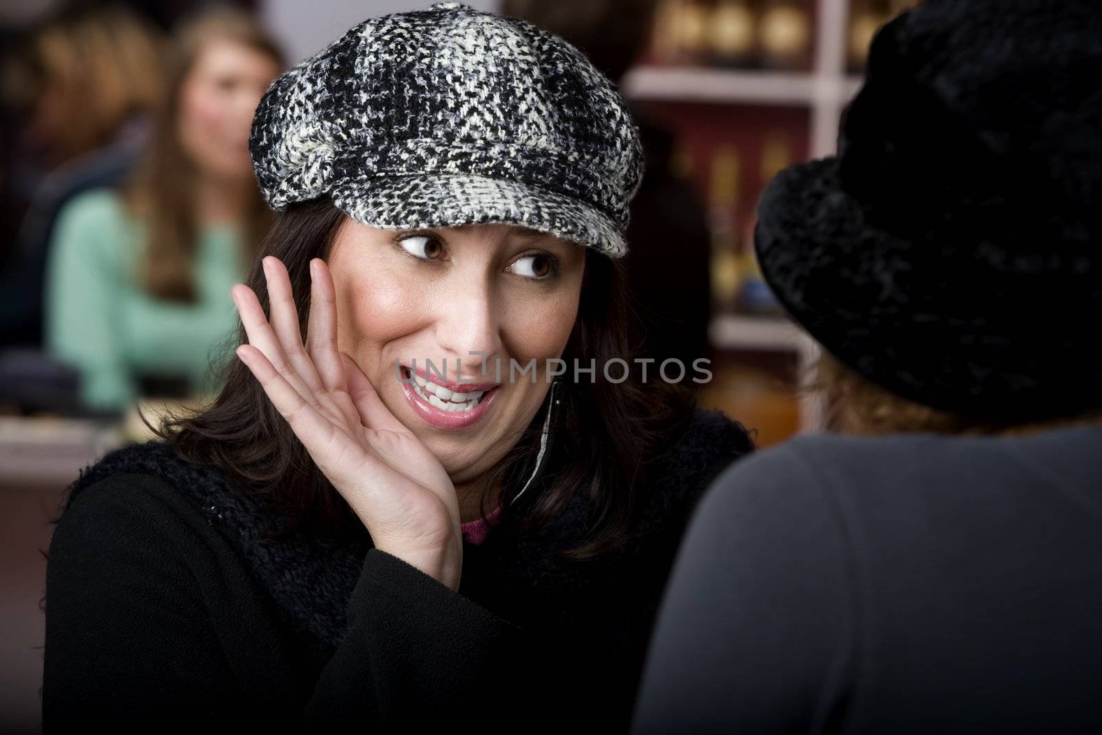 Pretty Hispanic woman with coffee sharing gossip