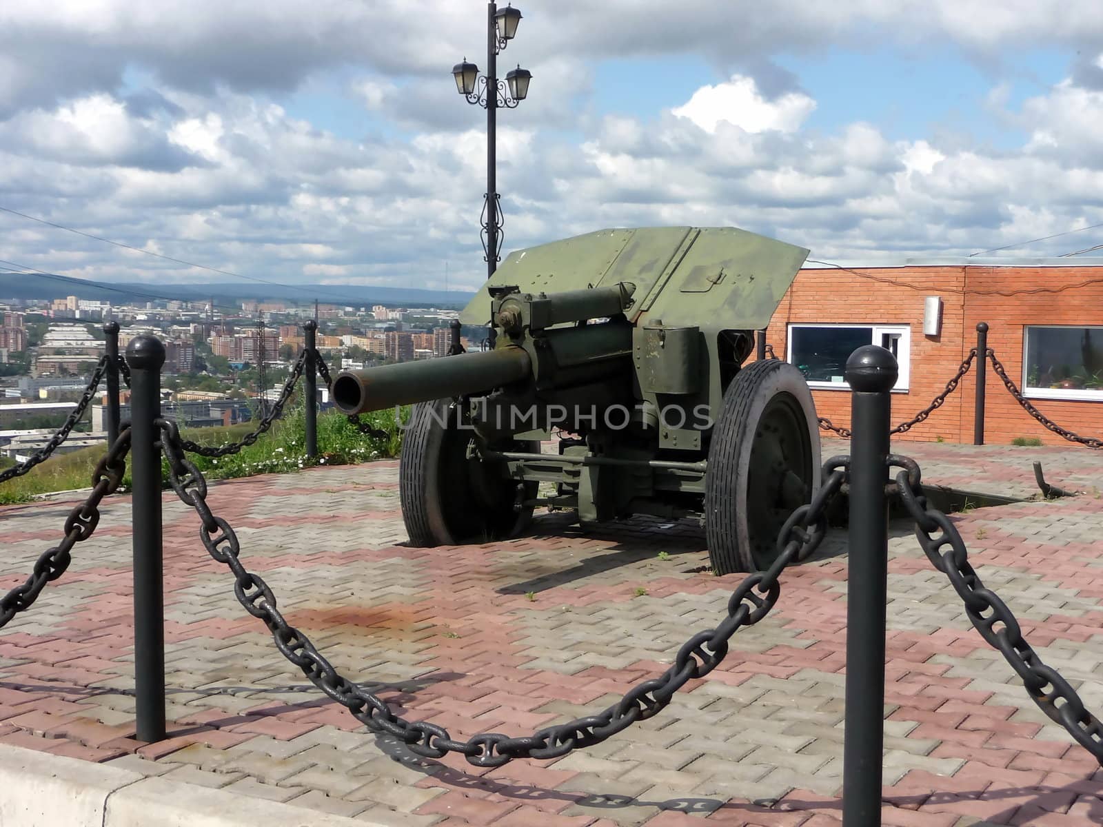 Green weapon gun on a background of Krasnoyarsk city in Russia