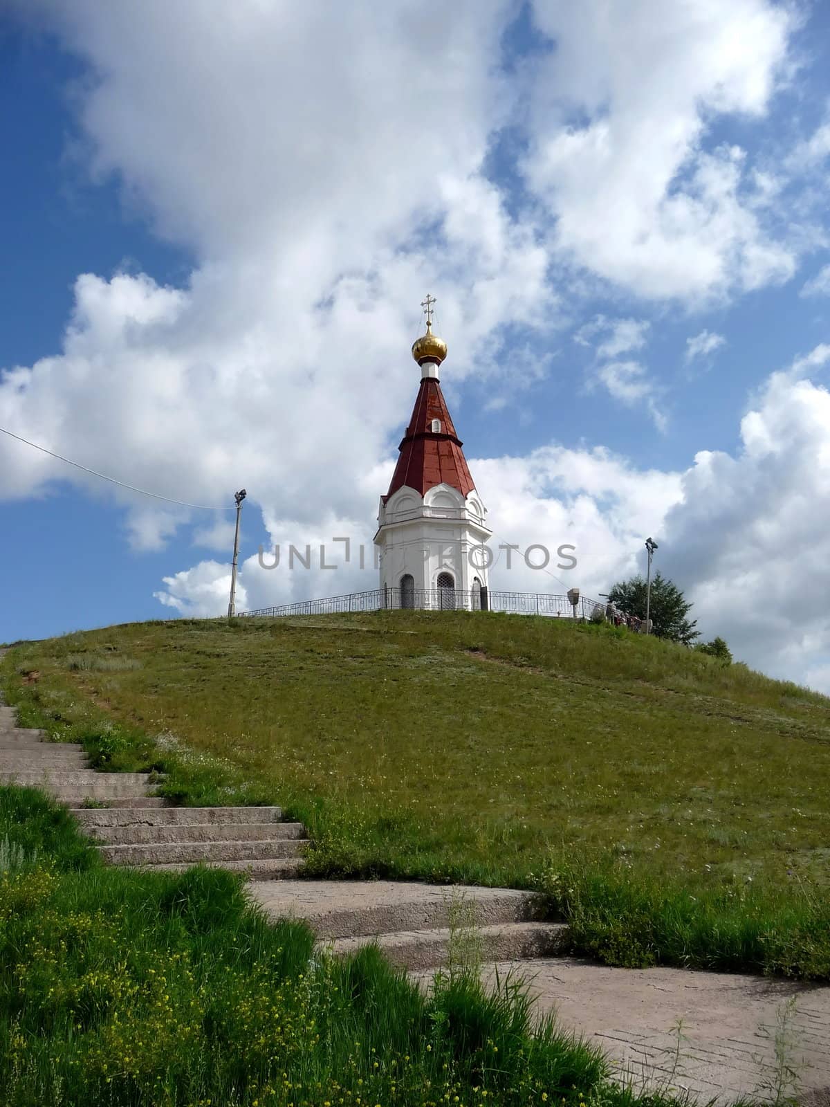 Old Russian temple in Krasnoyarsk on a background of blue sky with clouds