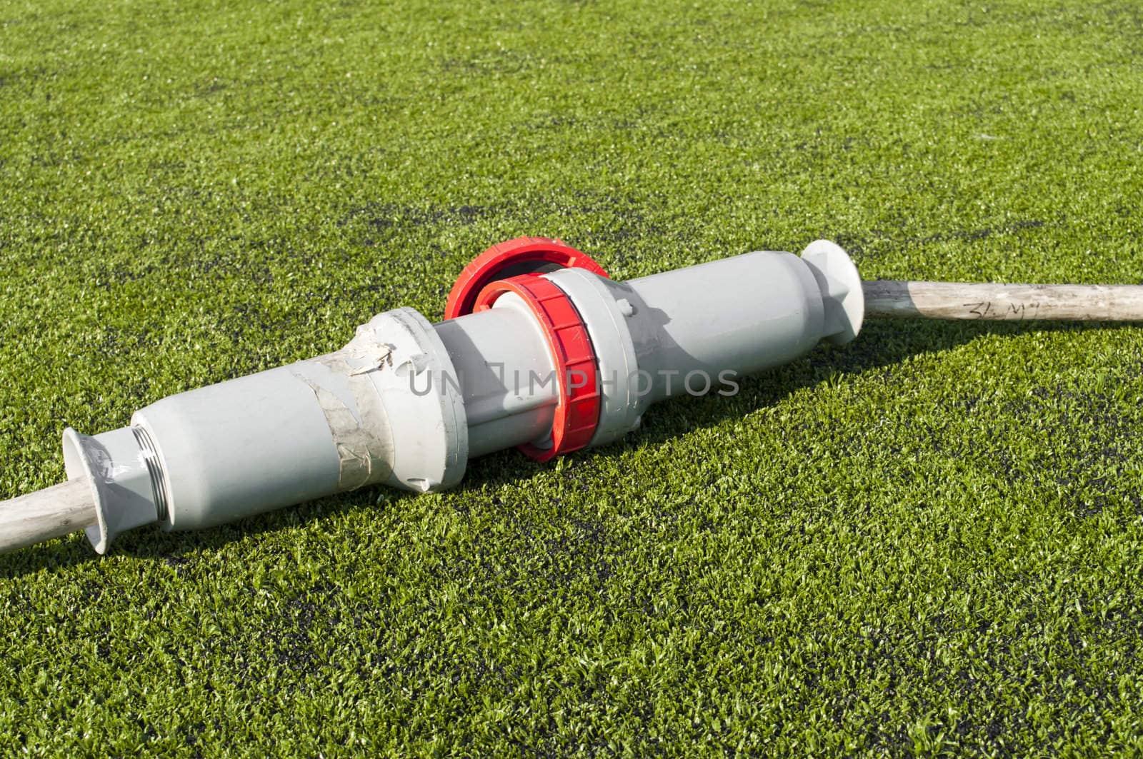 Connected wire in a soccer field on grass