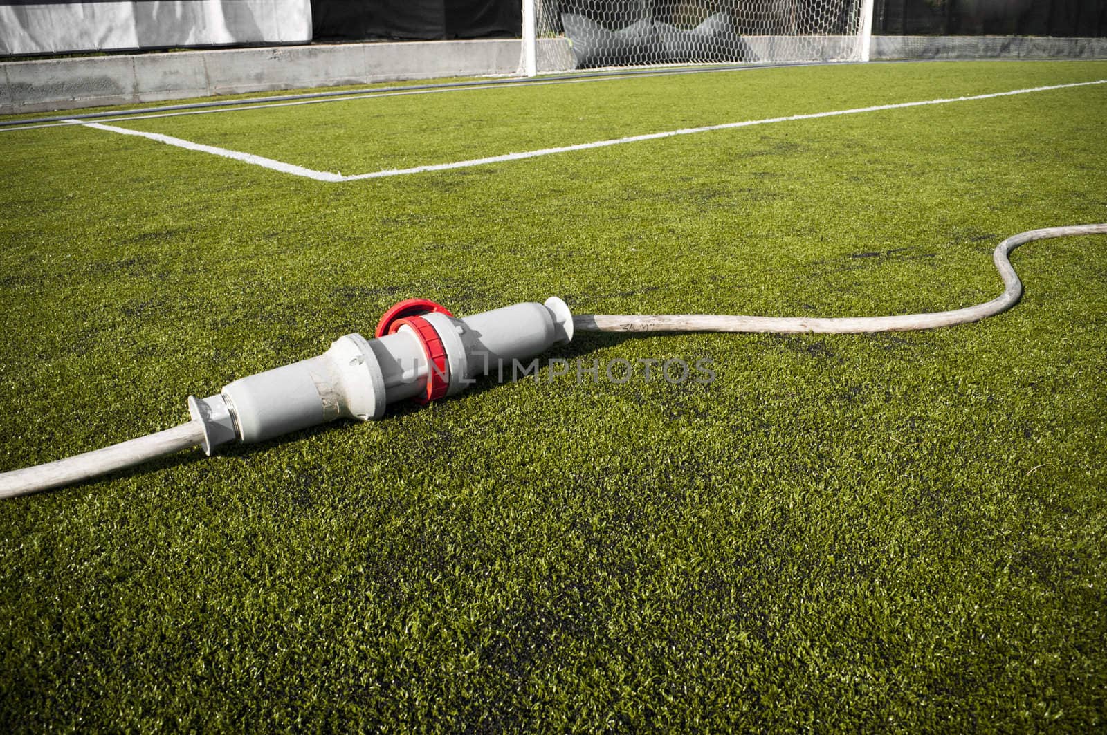 Connected wire in a soccer field on grass