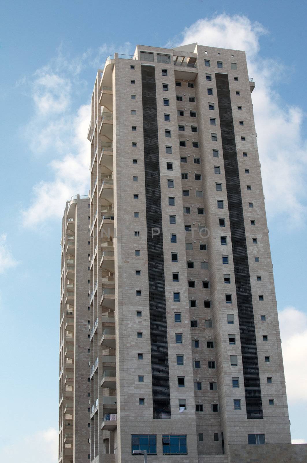 Front view urban apartment building with balconies .

