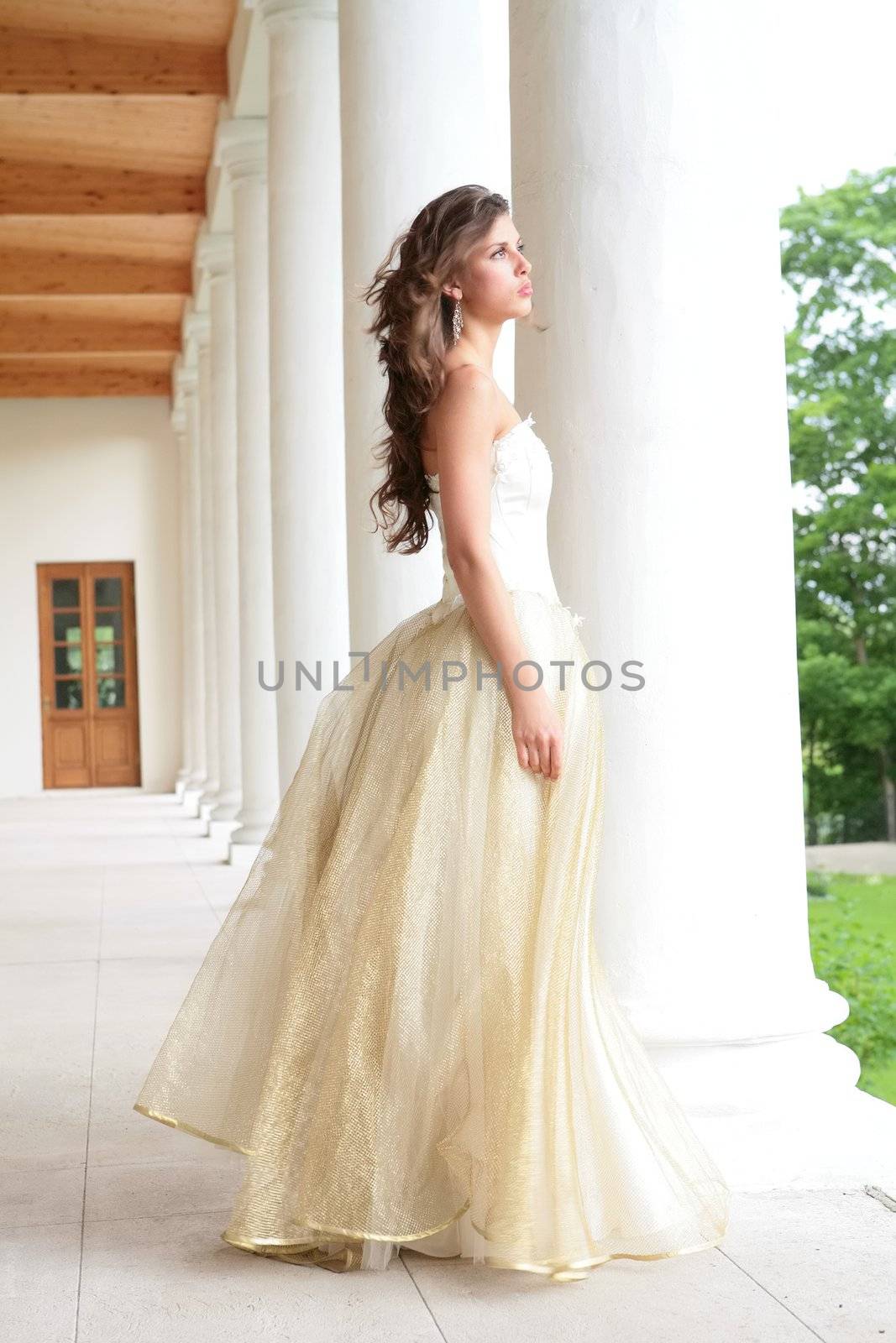 romantic portrait of the beautiful girl near pillars