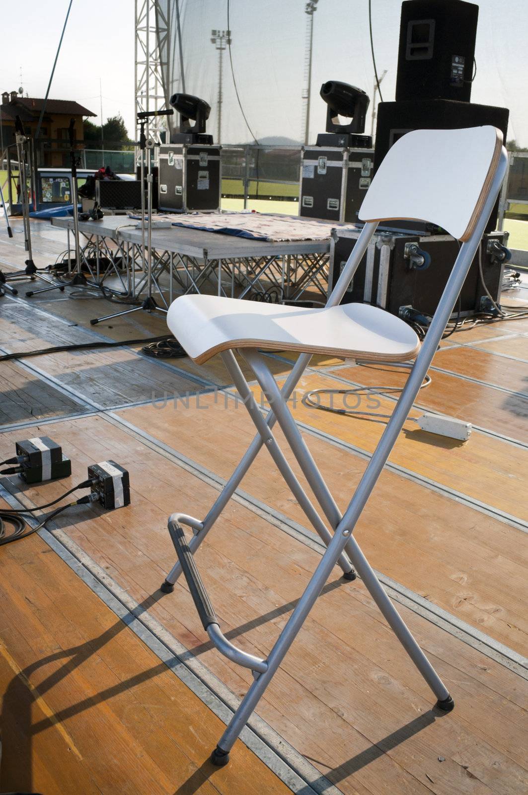 Chair on a wooden stage before a concert