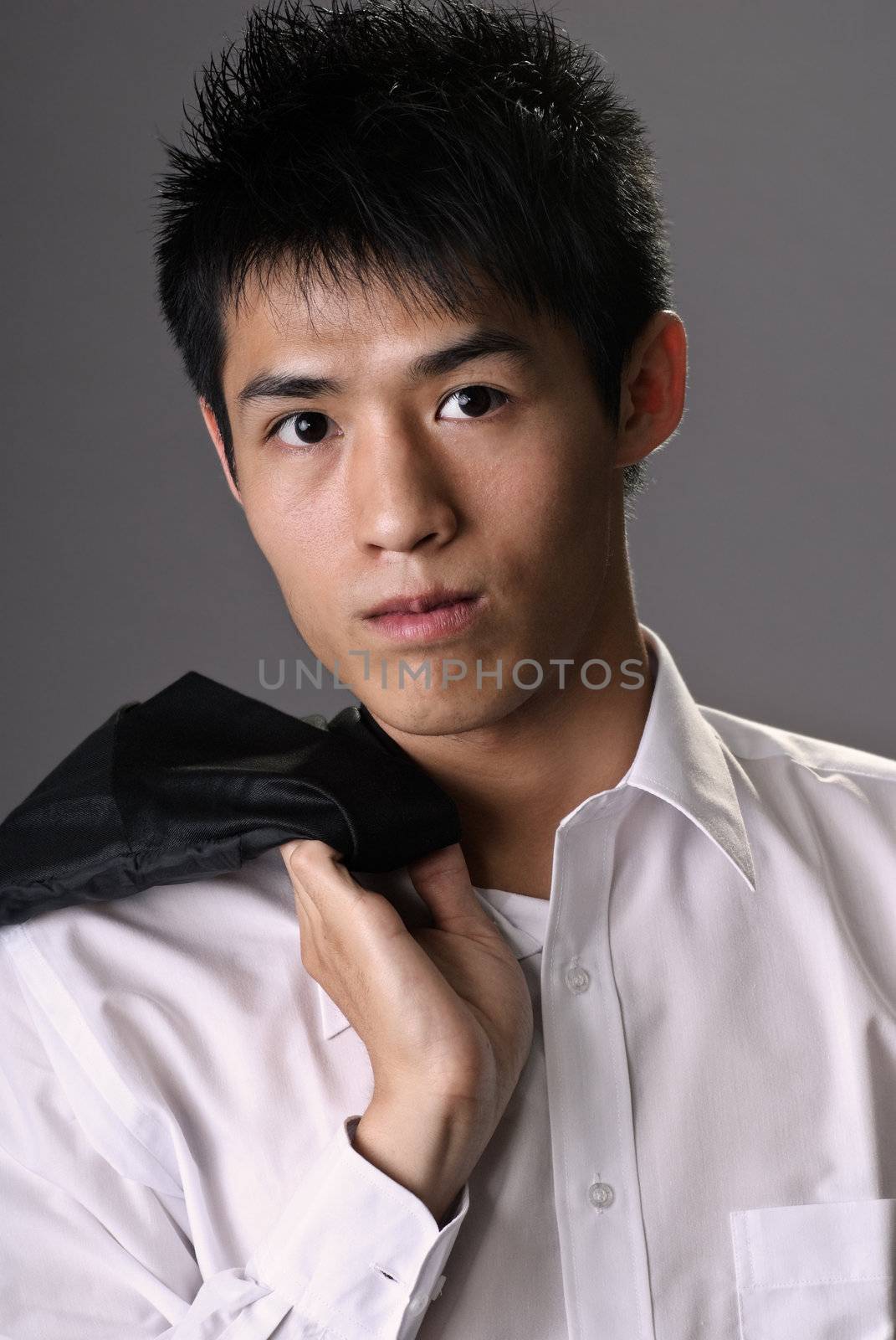 Young businessman portrait of Asian holding coast on shoulder when after work.