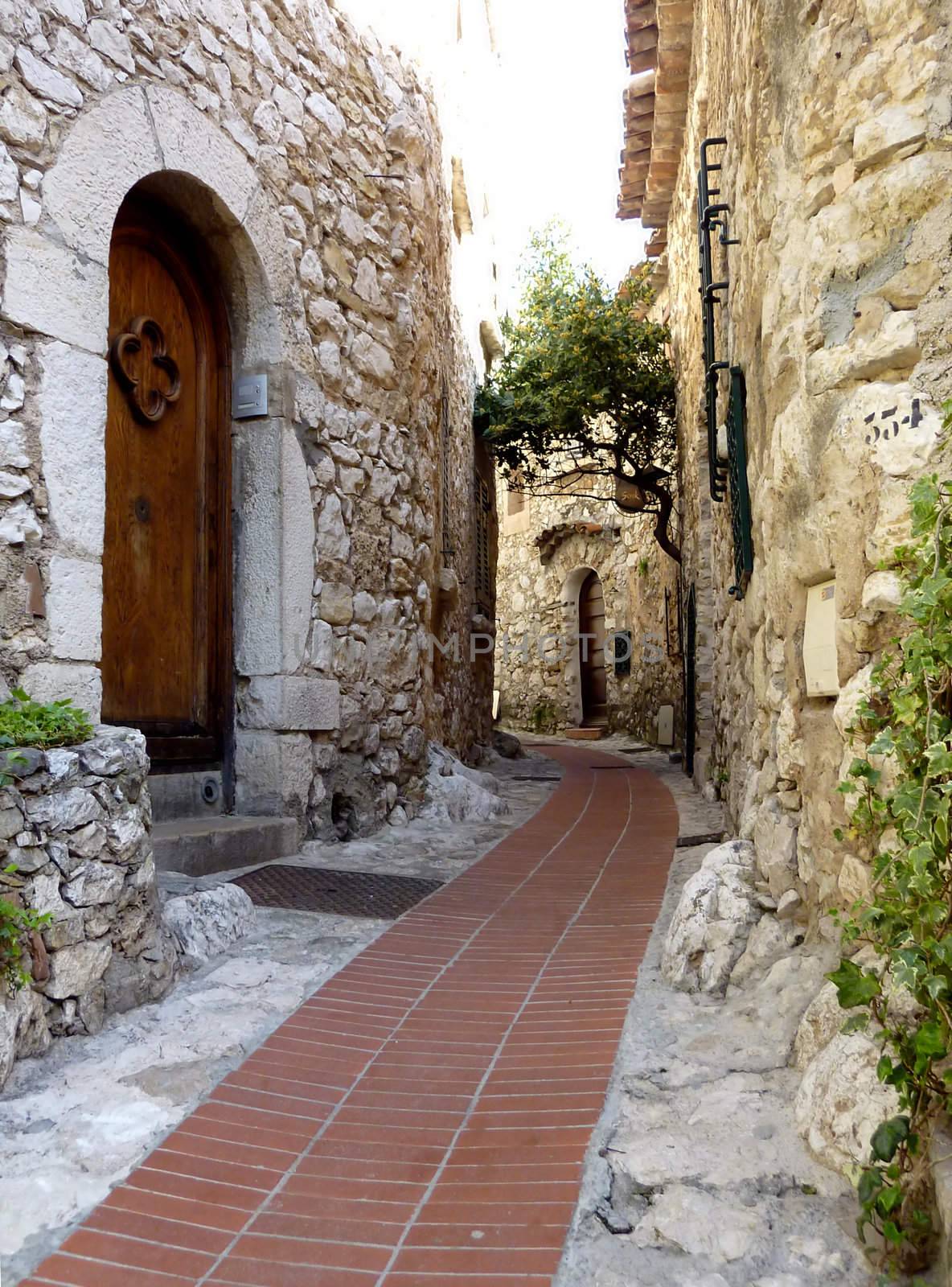 Street of old Eze village, south of France, and old brown door made of wood