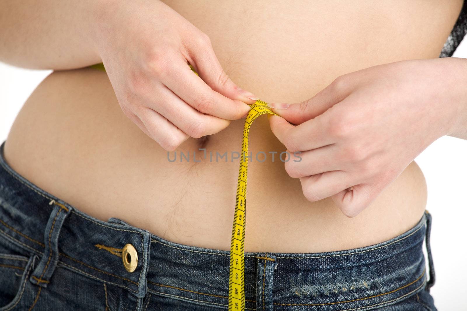 young girl measuring her belly
