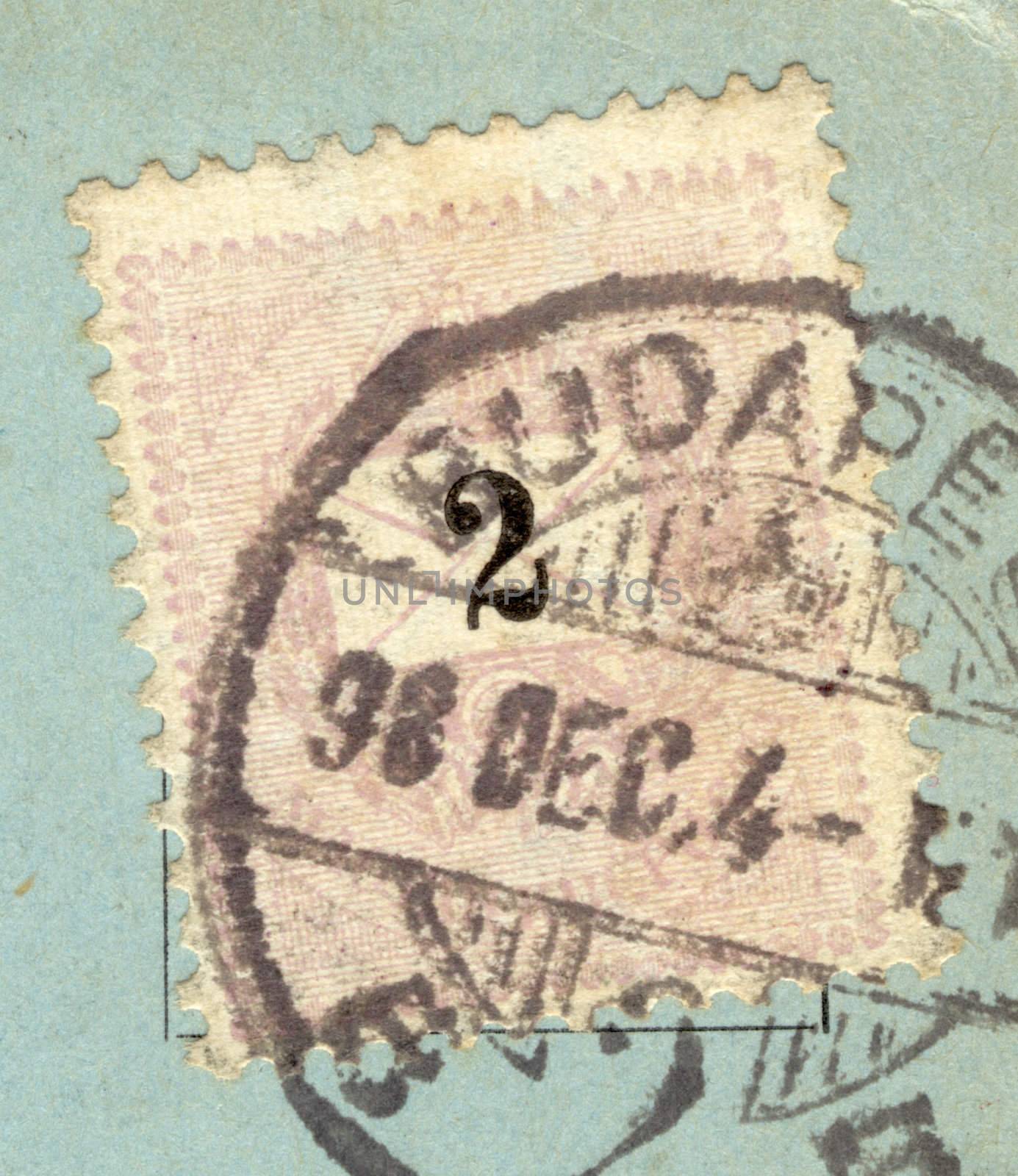 detail of vintage grungy postage stamp on blue postcard