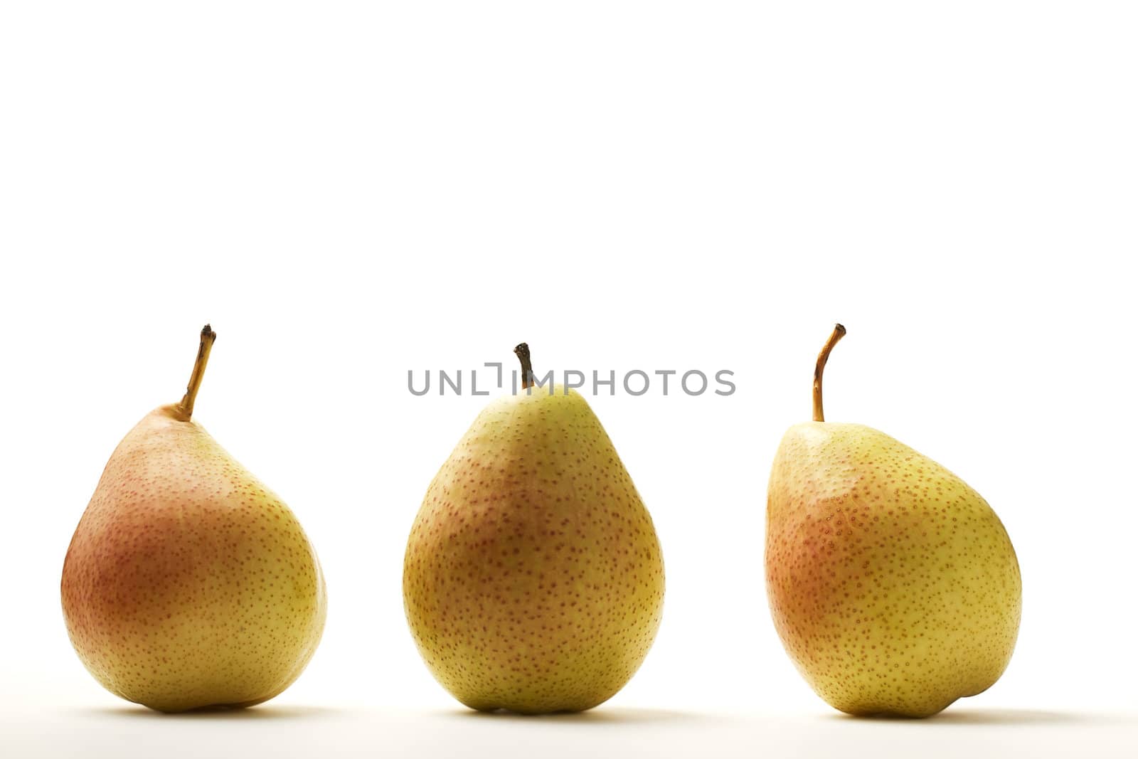 three pears in a row on white background