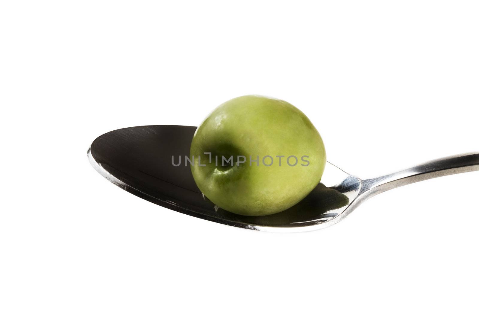 one green olive on a spoon isolated on white background