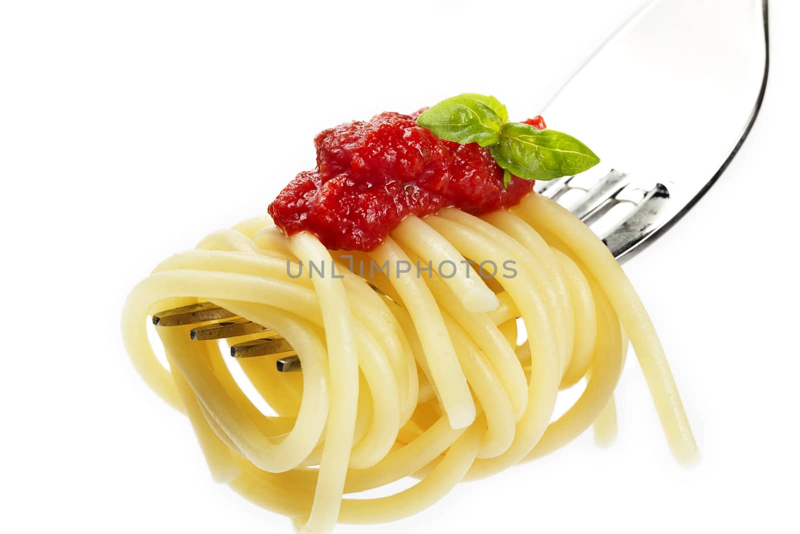 pasta with red sauce and basil on a fork on white background