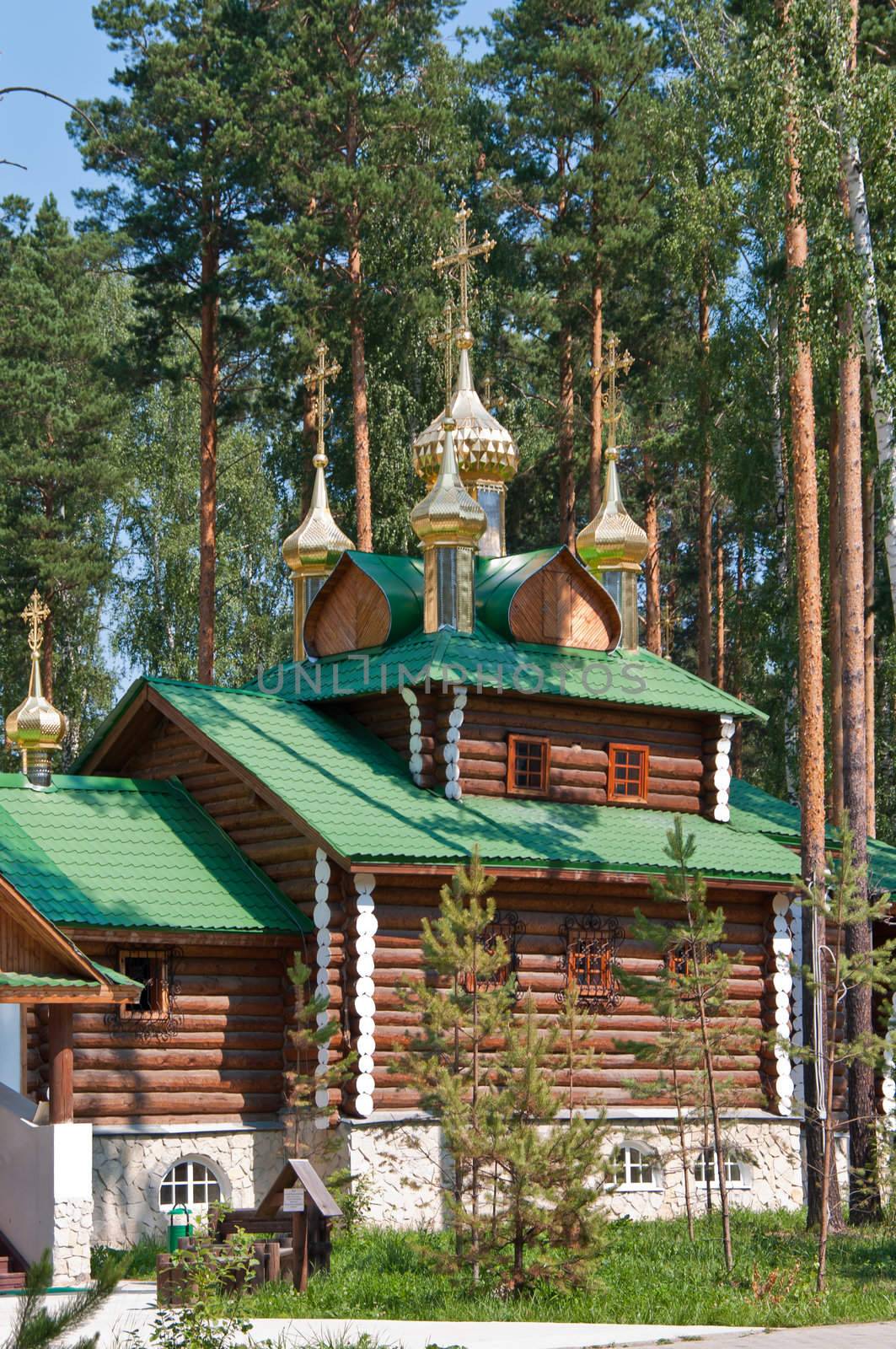 Wooden orthodox church among the trees by Shpinat