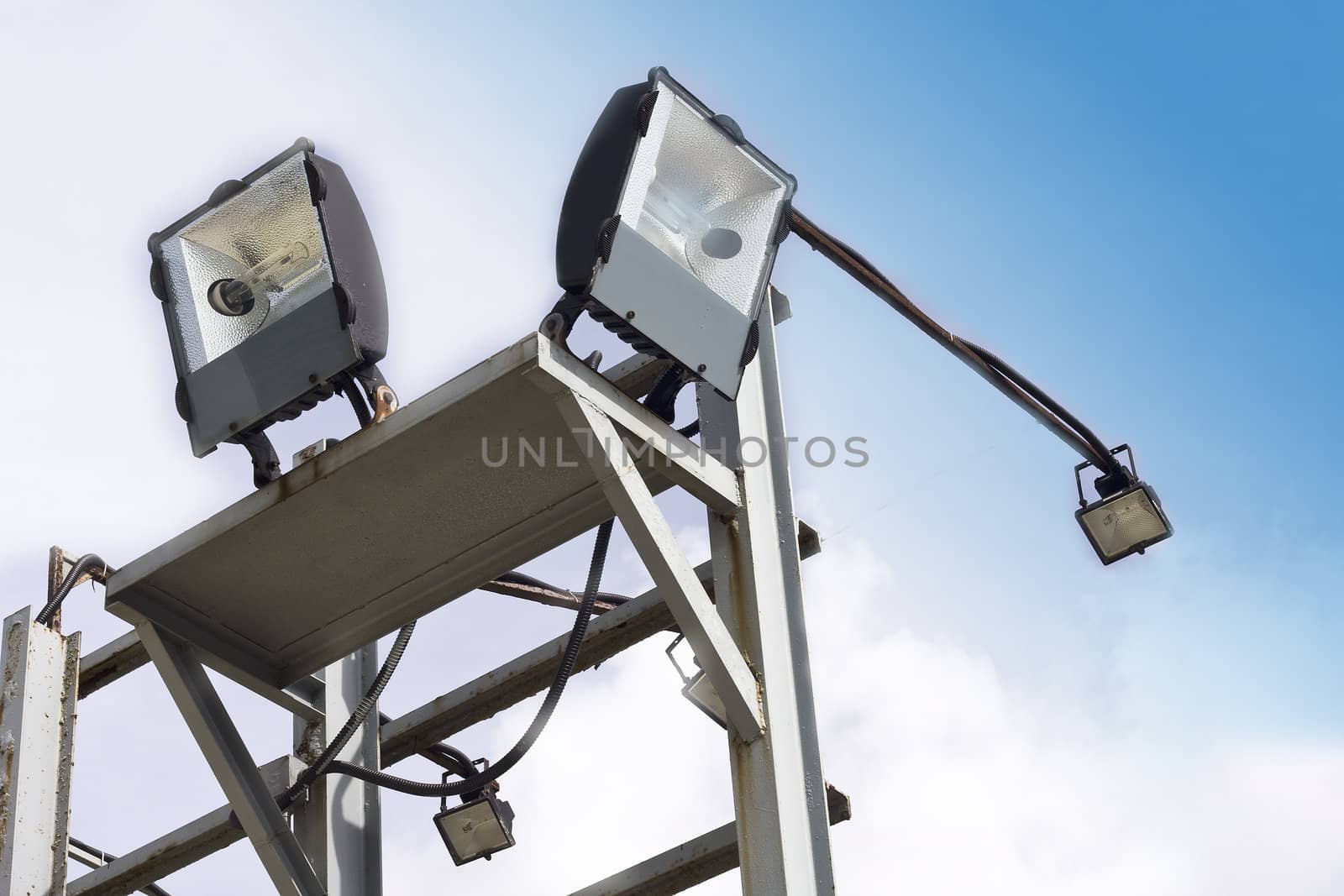 stadium lights against a blue sky 