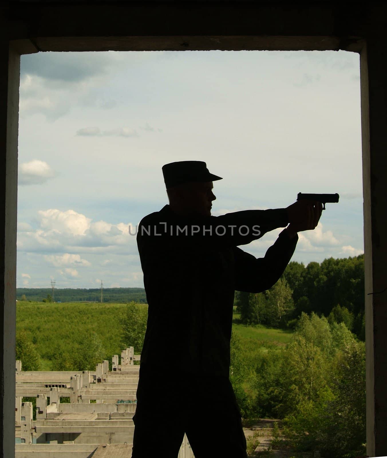 The Contour of soldier with a gun opposite to window with peace landscape. by palomnik