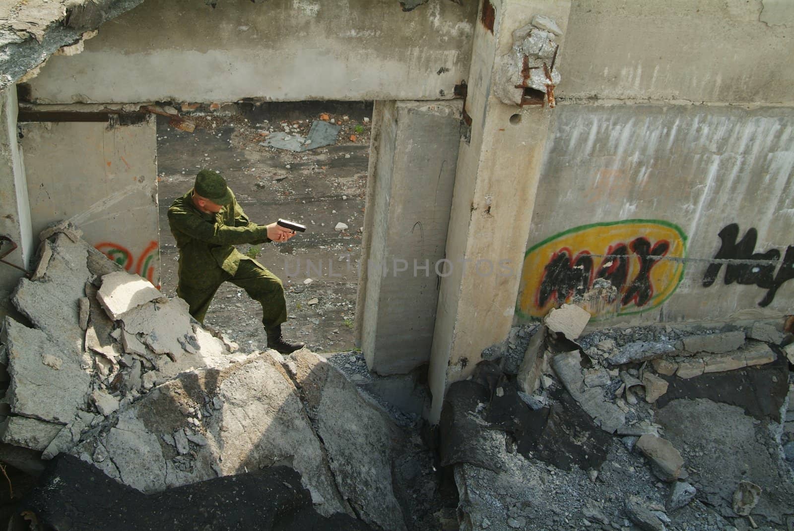 The soldier with a pistol performs antiterrorist operation.