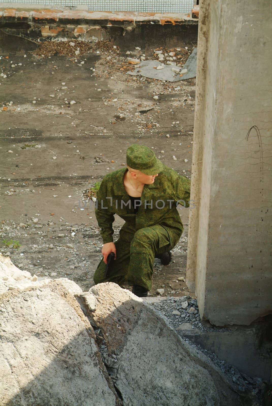 The soldier with a pistol performs antiterrorist operation.