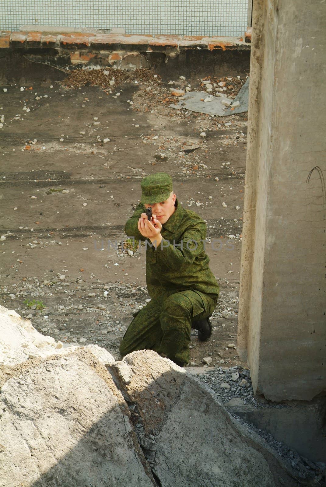 The soldier with a pistol performs antiterrorist operation.