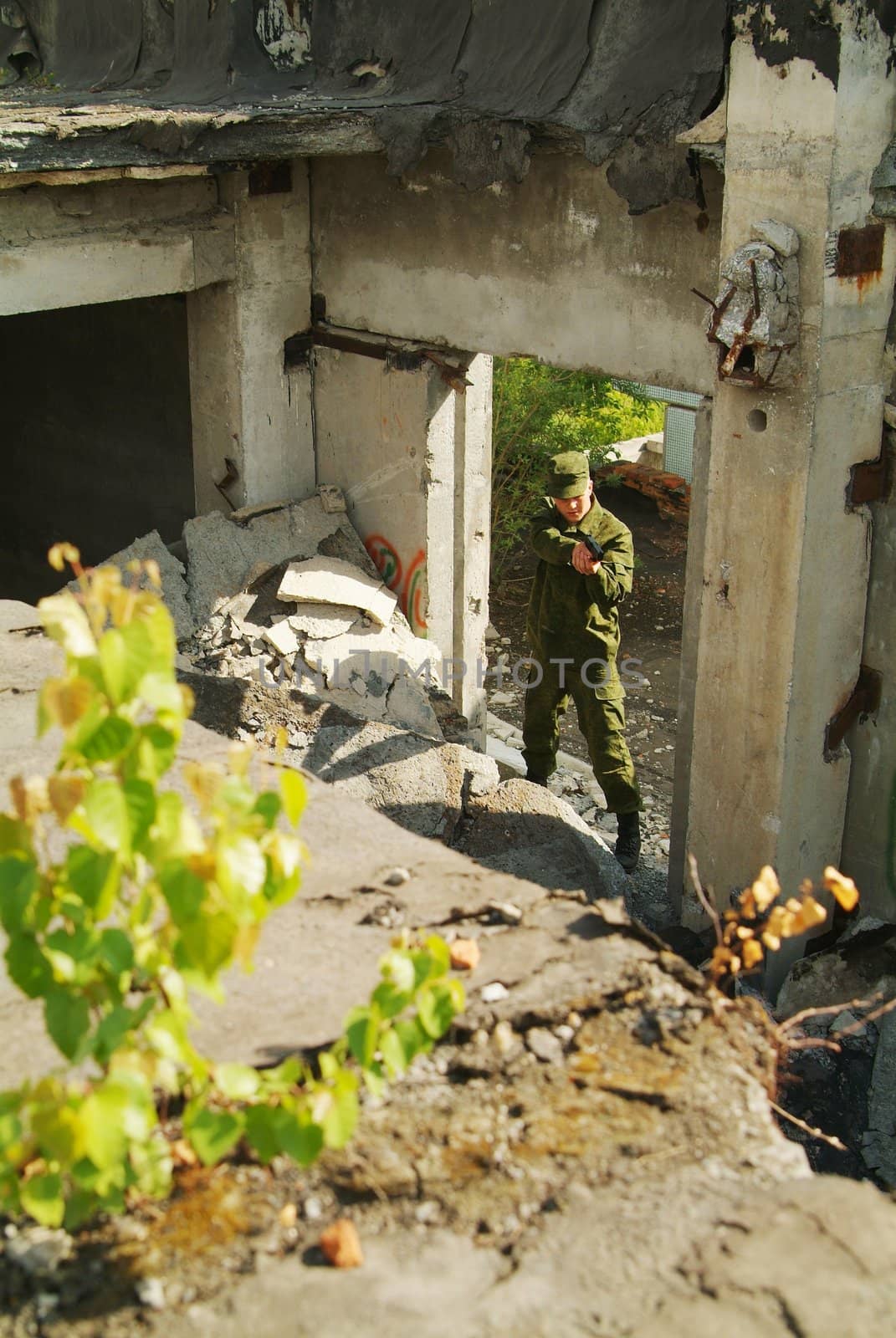 The soldier with a pistol performs antiterrorist operation.