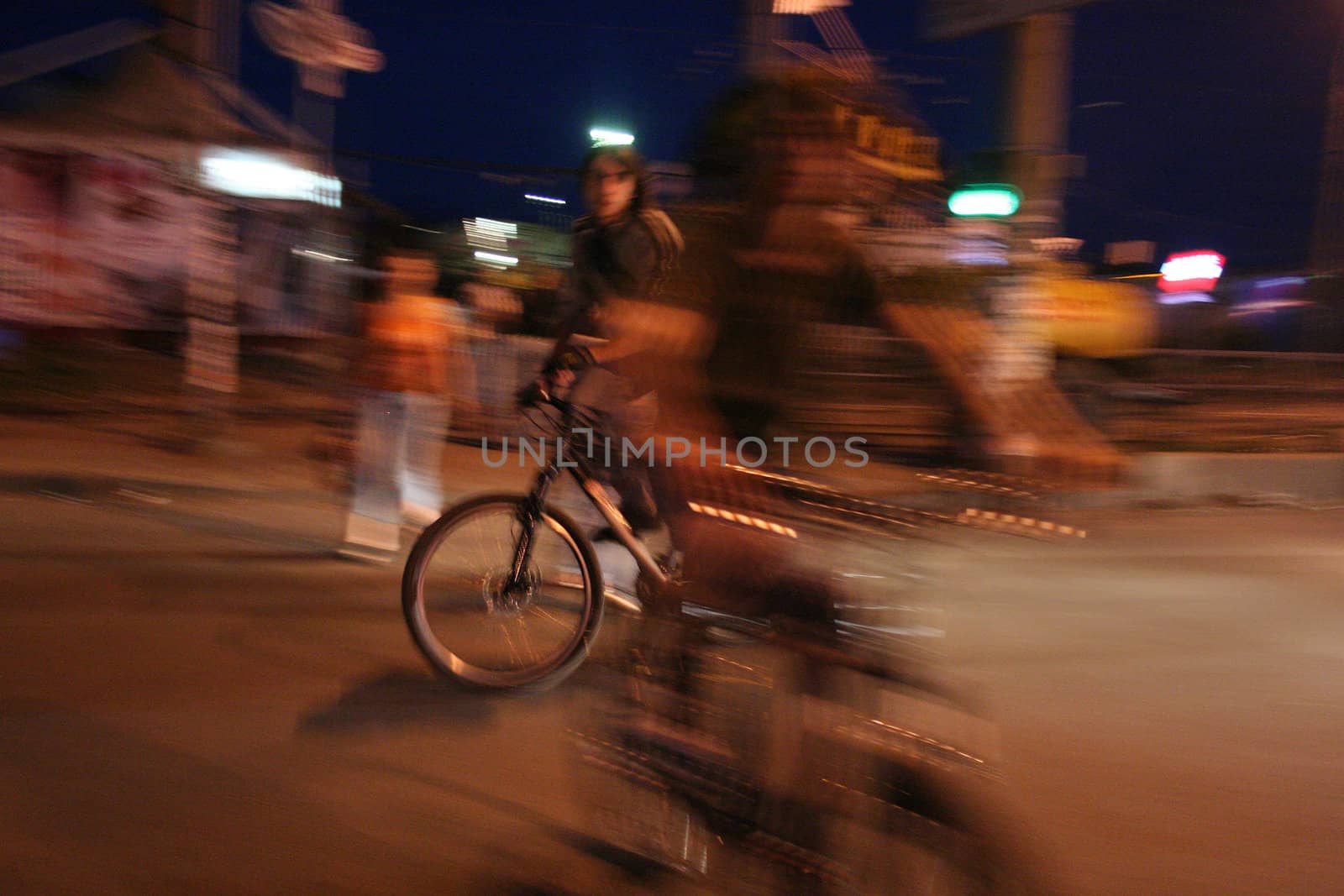 
The young man with a bicycle in the evening in the street cities of Kharkov Ukraine on June, 5, 2007