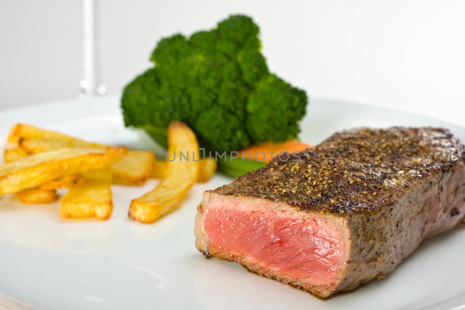 grilled steak on a plate with fries