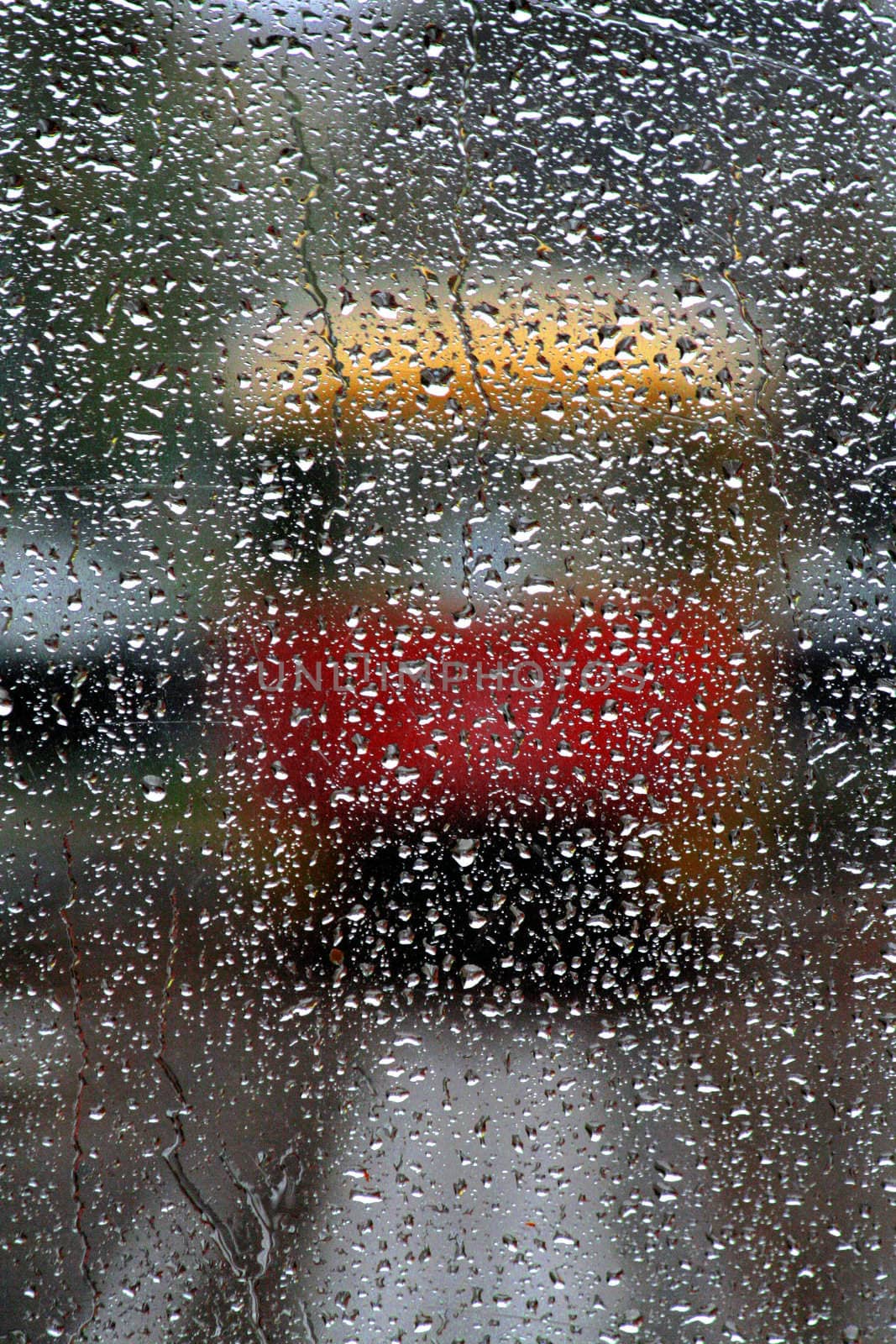 Drops of a rain on frontal flown down a tram which has stopped on a line