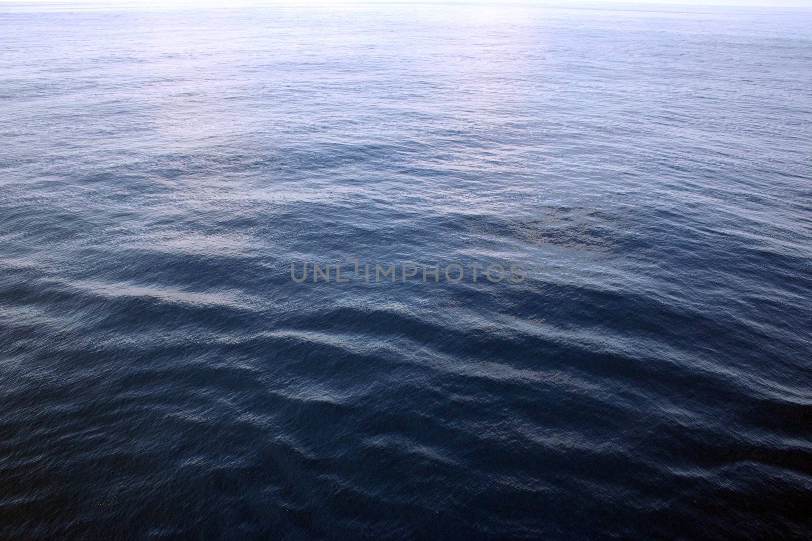 A clear shot of wide open ocean water. Great background picture.