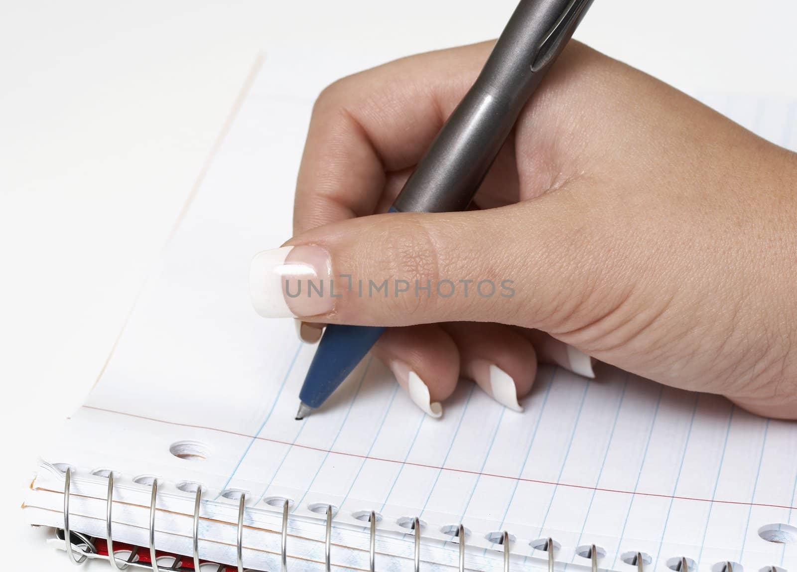 a macro picture of a female hand holding a pen