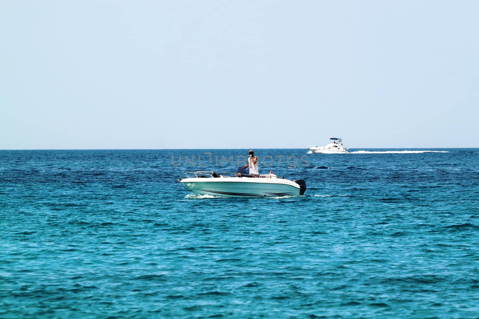 A white speedboat on open sea by artush