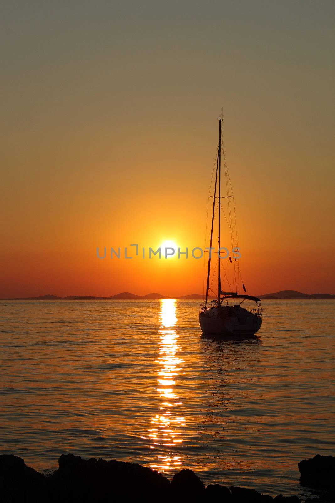 Gold romantic sunset with silhouette of yacht