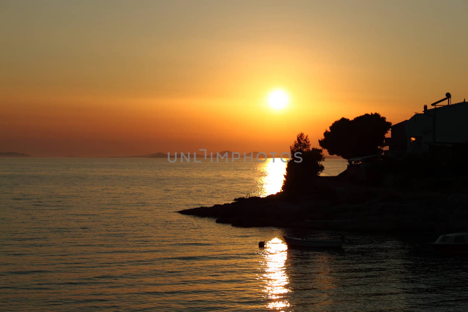 Romantic sunset with silhouette of coast