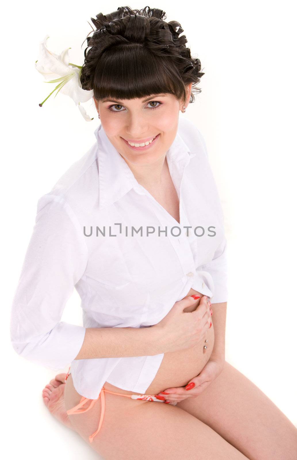 Happy pregnant woman in white t-shirt on isolated background
