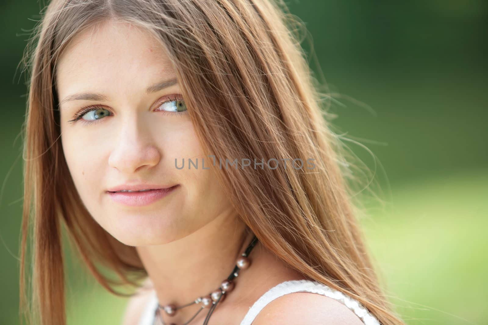 portrait of the young beautiful girl on green background