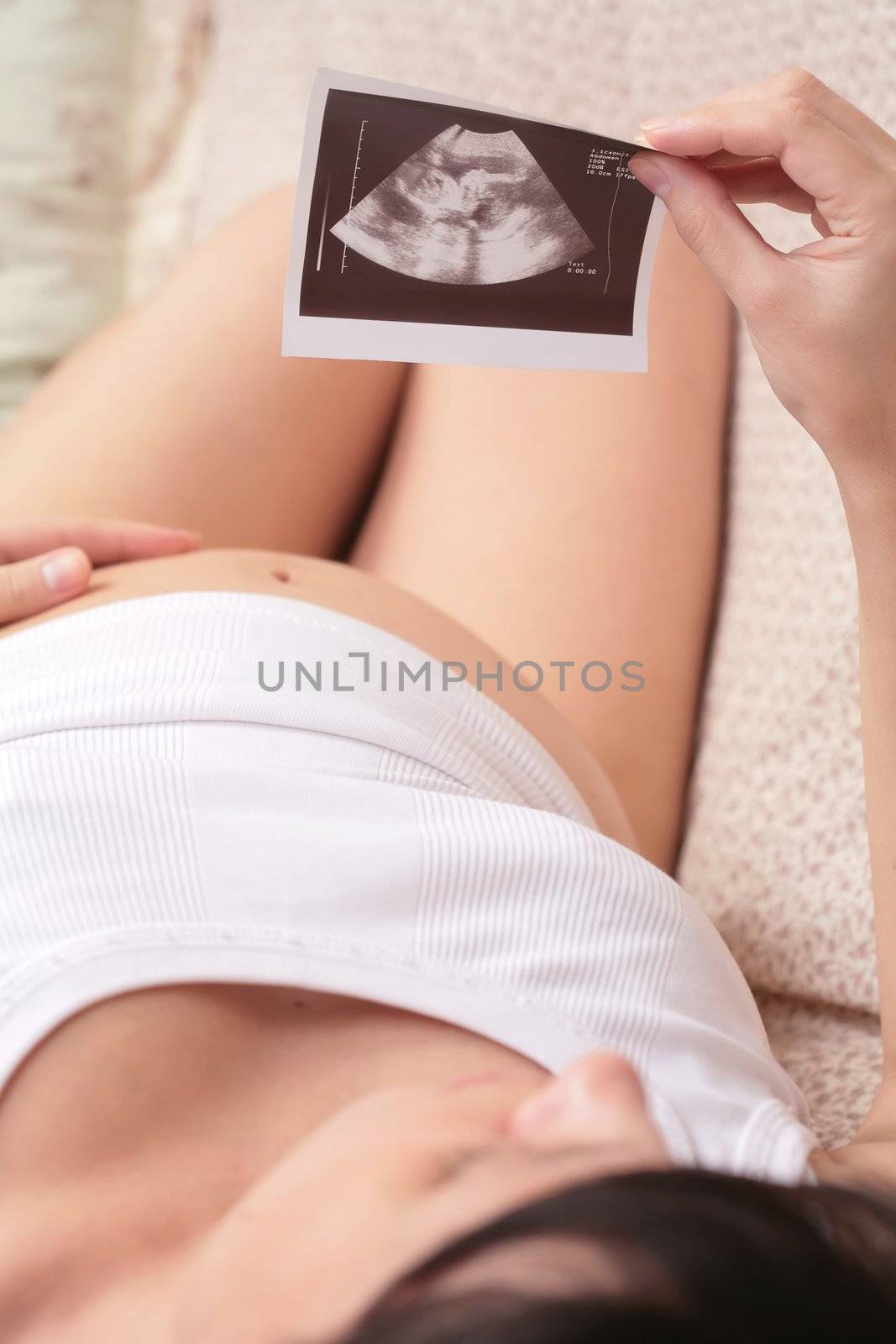 Mother watching ultrasound of her unborn baby