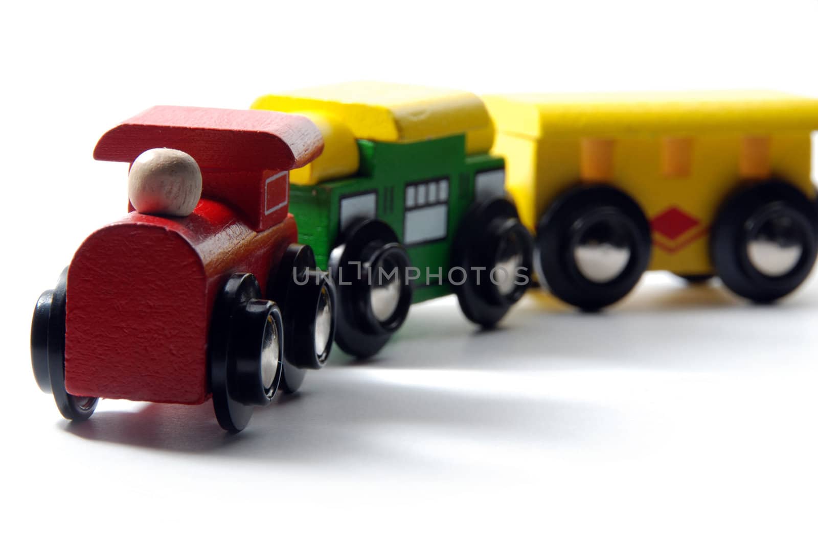 Wooden toy train with soft shadow isolated on white