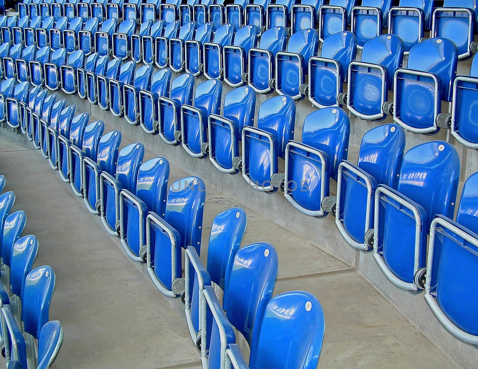 Photographic image of plastic folding chairs on sports arena.