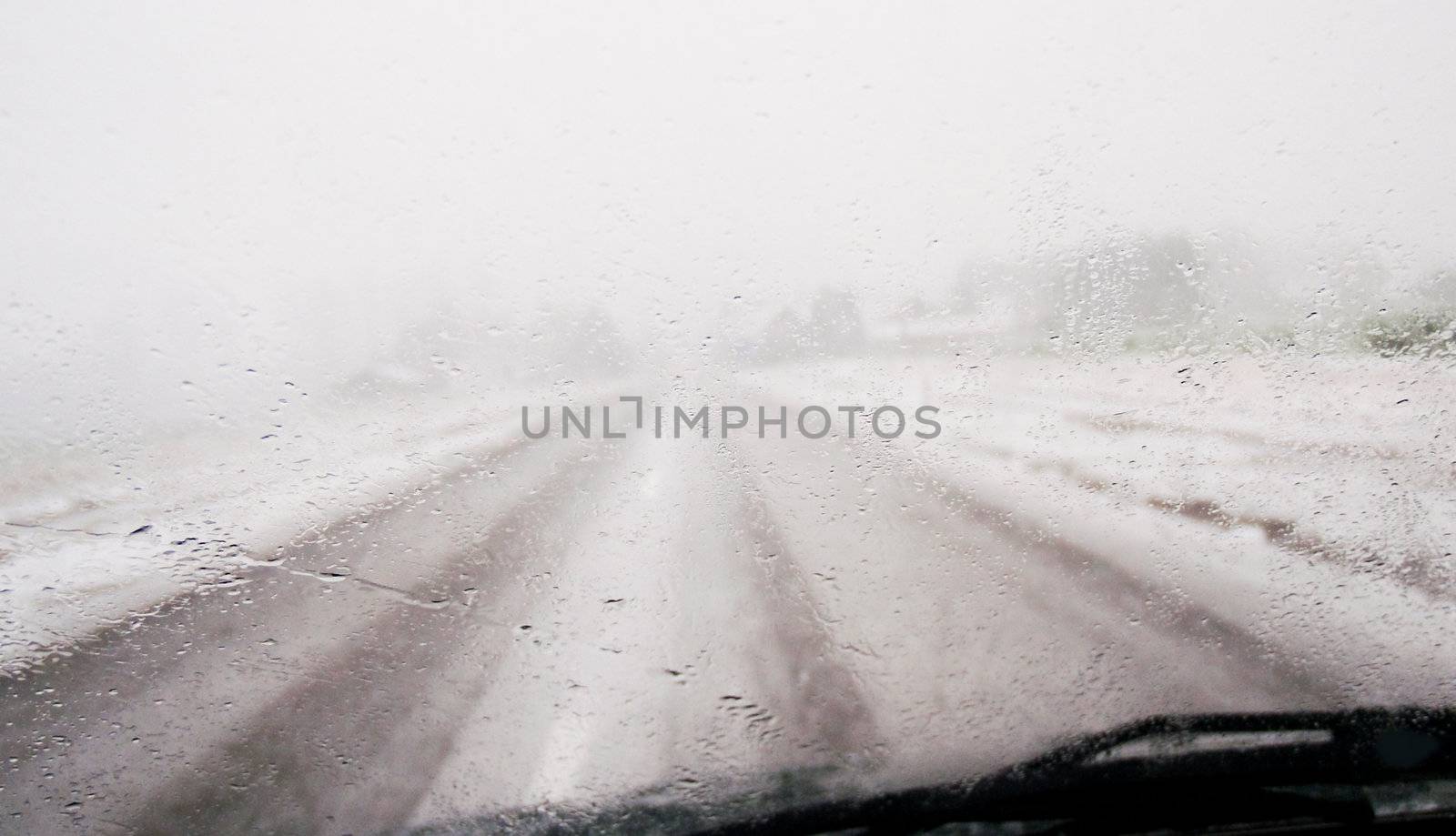 view through wet car window in a winter landscape
