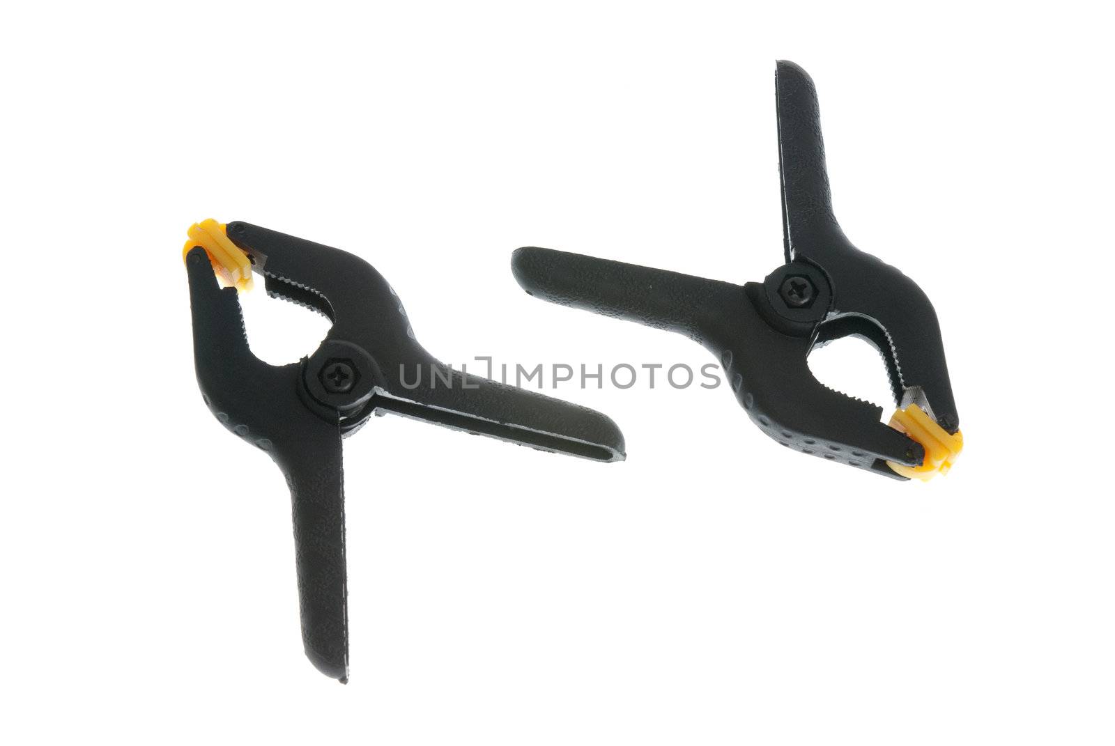 Yellow and black plastic clamps isolated on white background.
