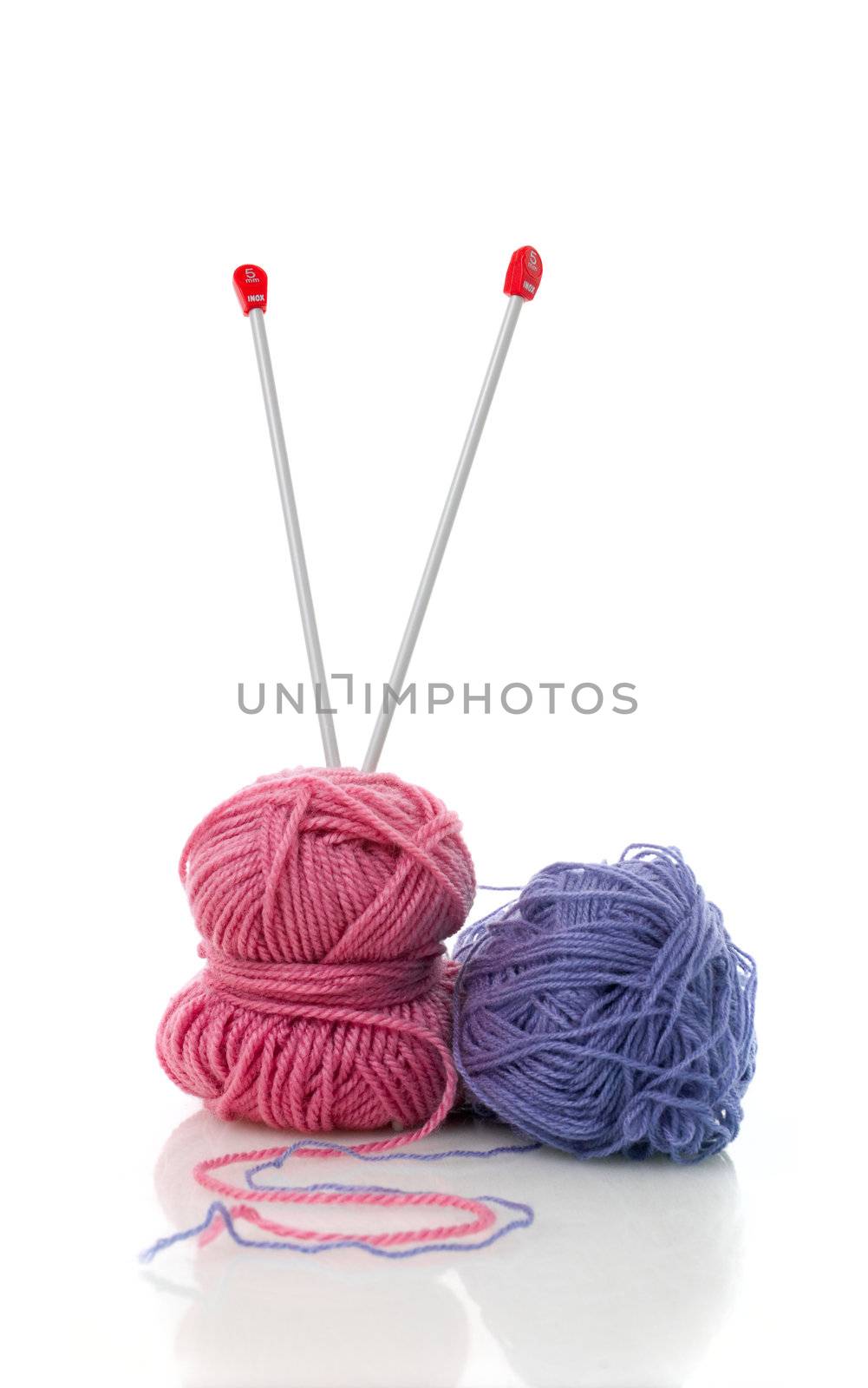 Balls of blue and pink  knitting wool or yarn, with silver knitting needles.