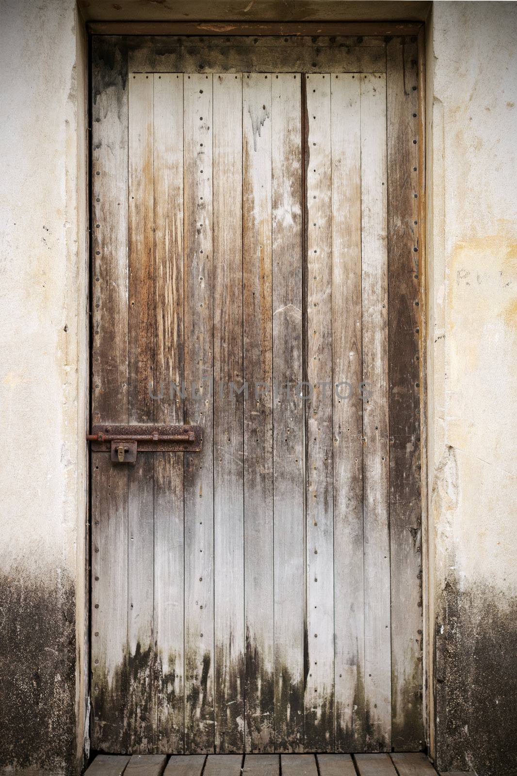 Old closed wooden door by Jaykayl