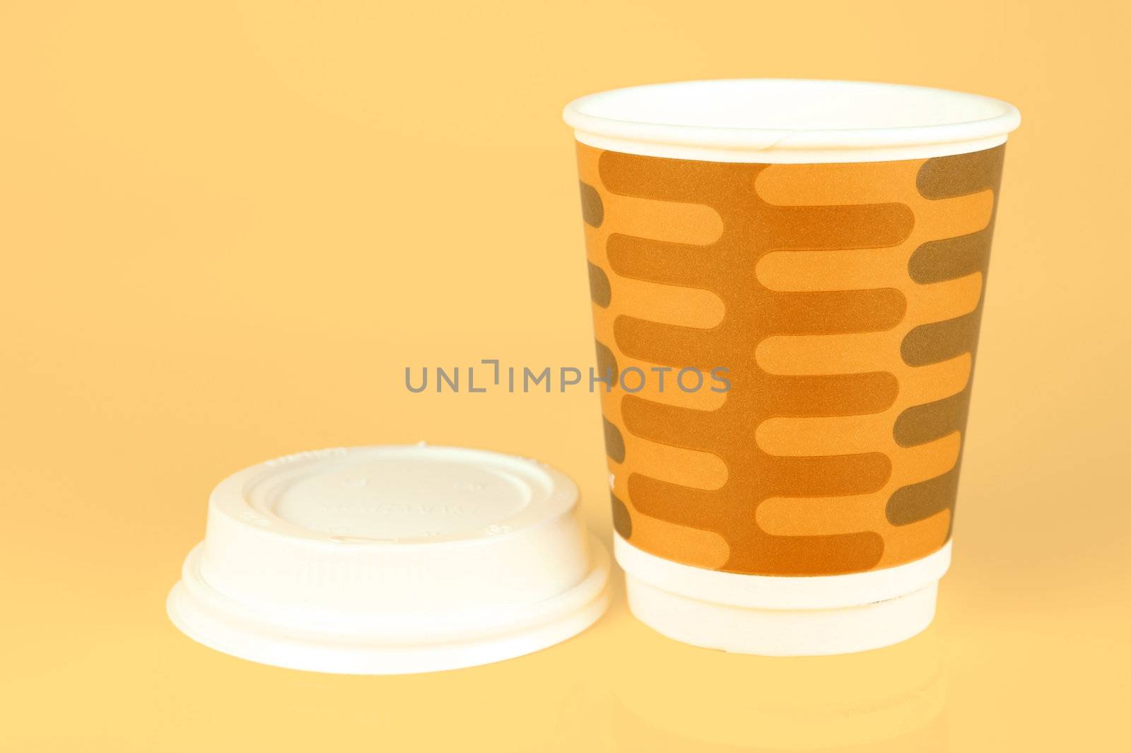 Takeaway coffee cups isolated against an orange background