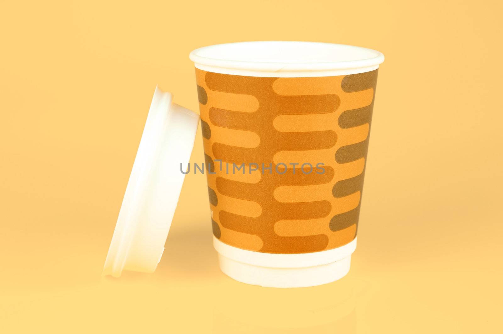 Takeaway coffee cups isolated against an orange background