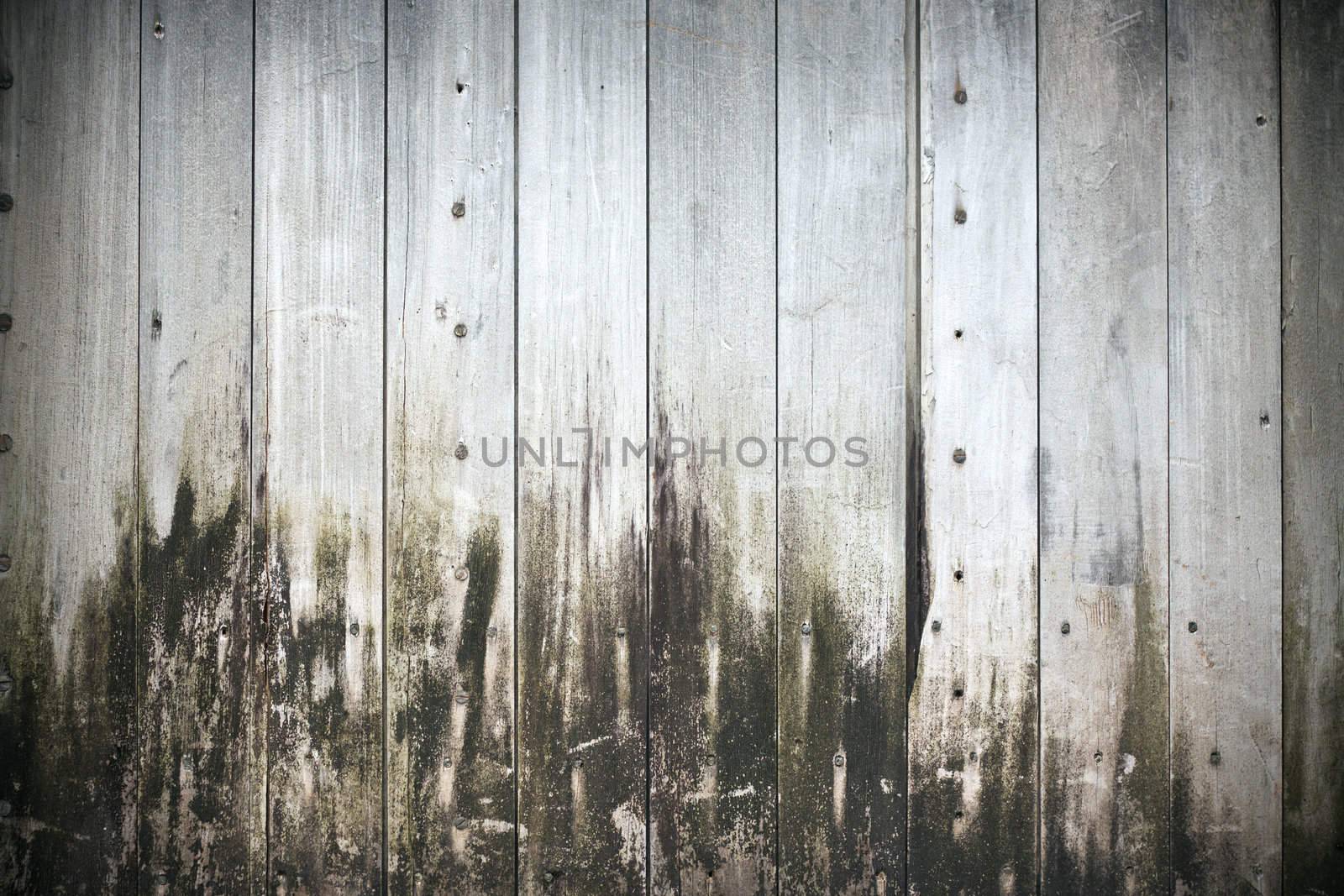 An old grungy stained wooden background