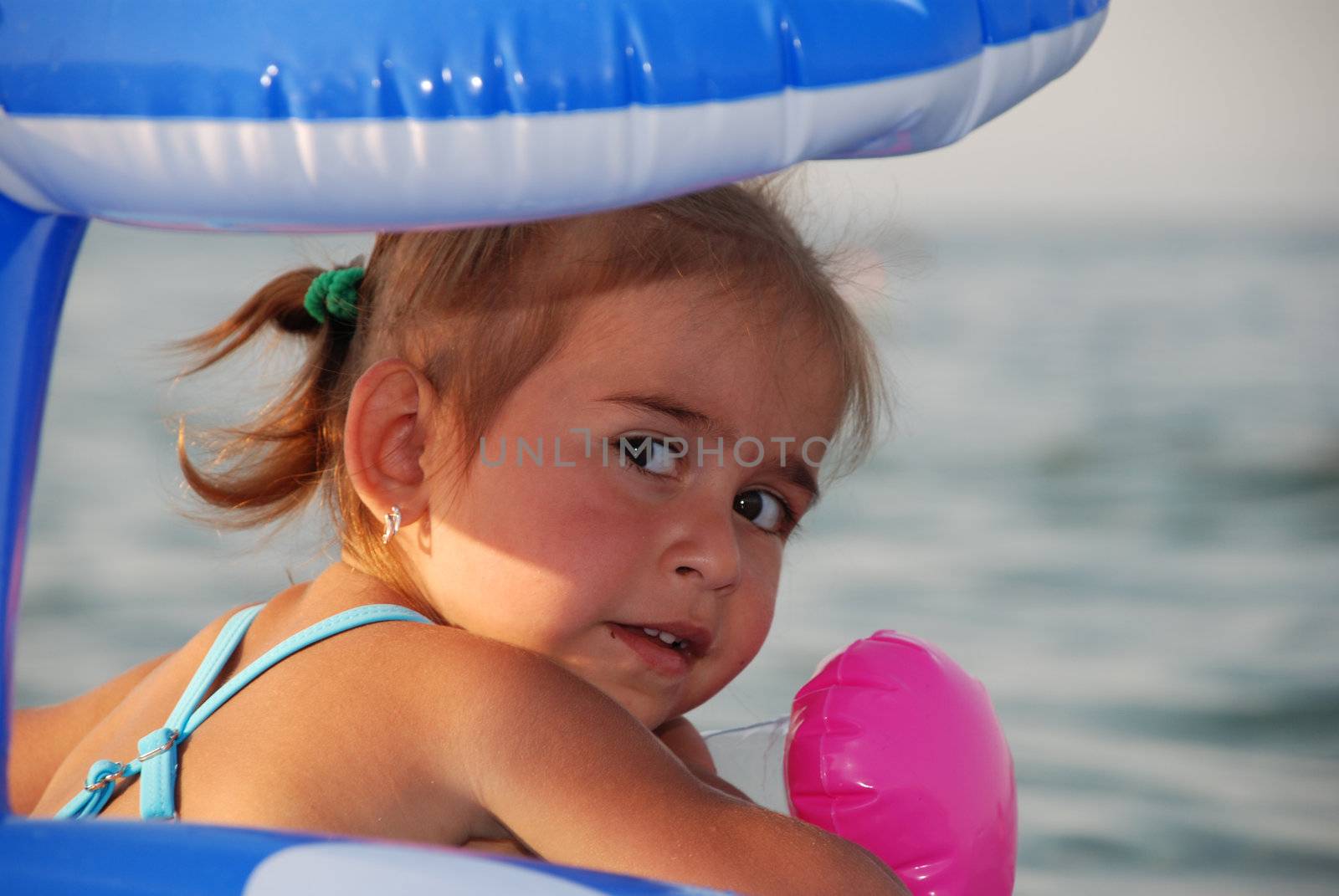 On the sea. The girl floats on an inflatable circle