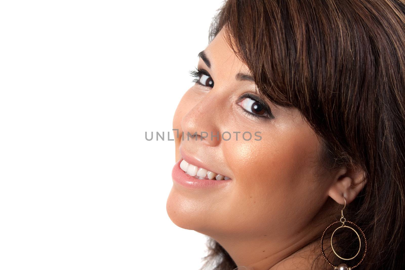 A smiling Spanish model with a very clear complexion isolated over a white background.  She has black hair with brown highlights.