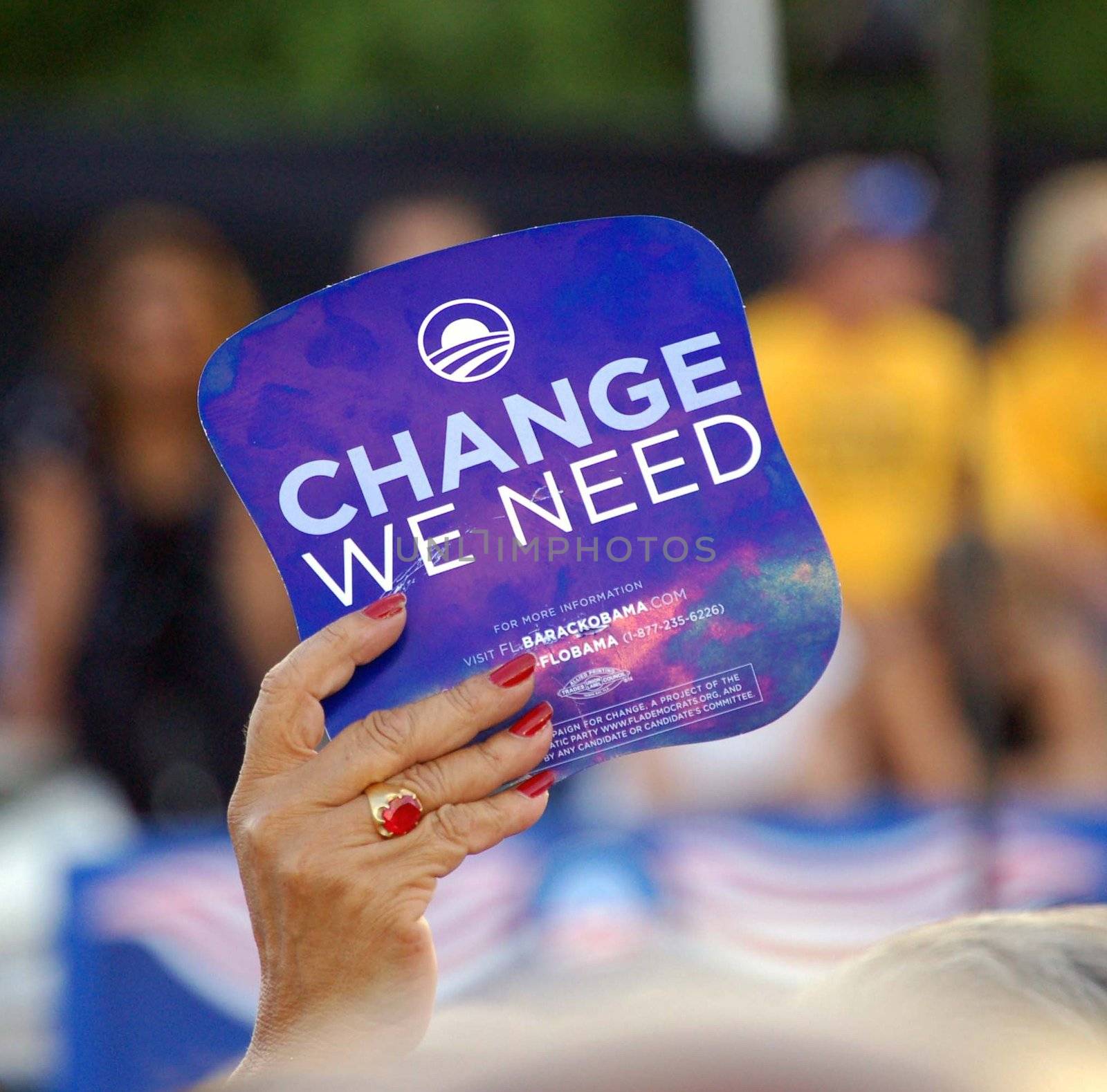 Hand holding a "Change We Need " placard at an Obama Rally in Bay Front Park,Miami Florida in October 2008