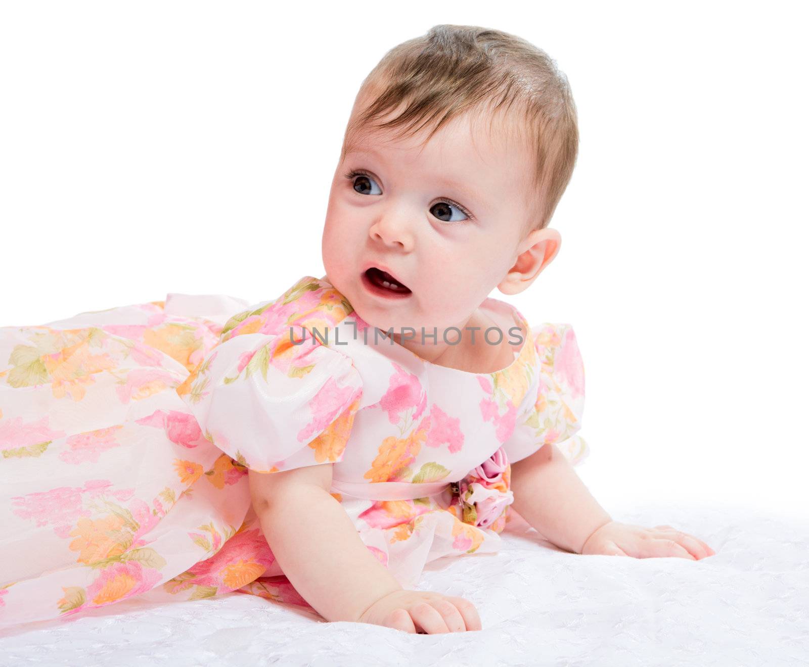 Happy baby wearing beautiful holiday dress lying on blanket