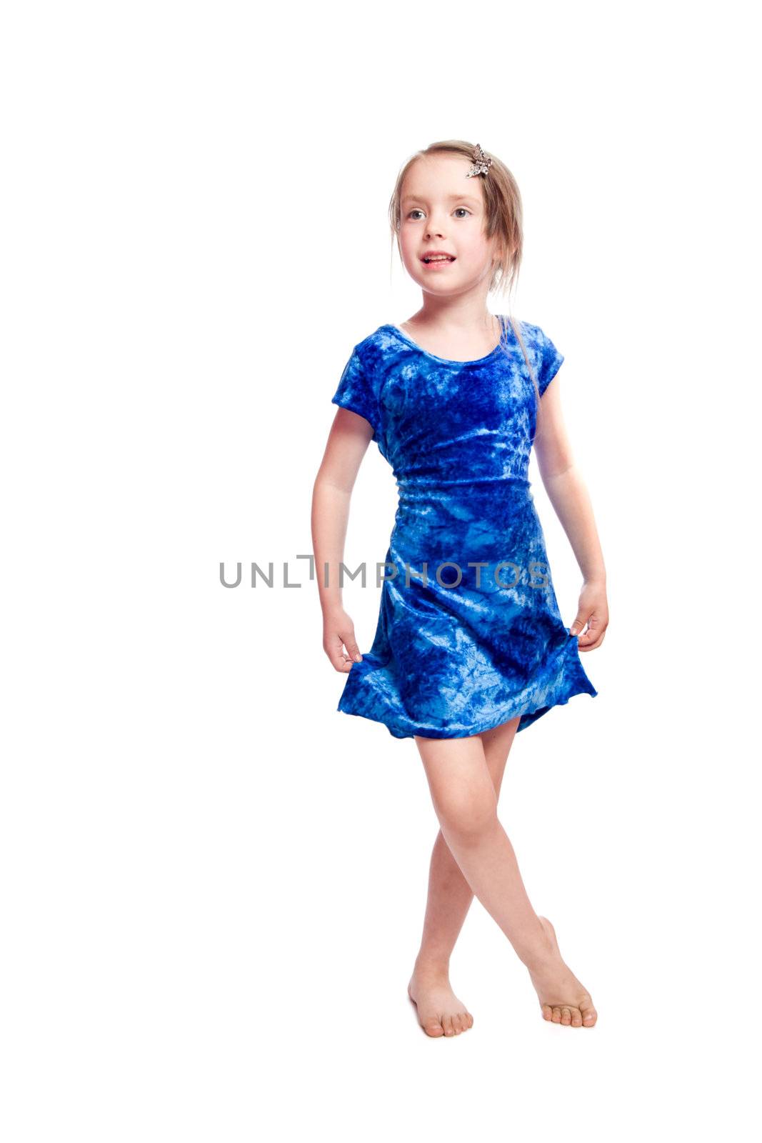 Dancing little girl wearing blue dress isolated on white