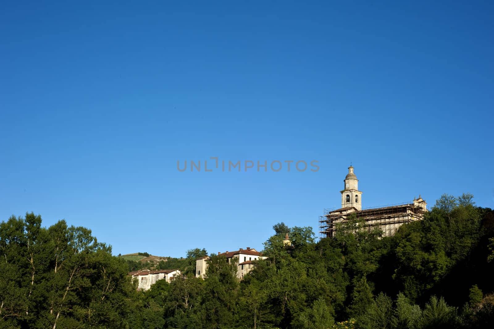 Ancient Italian village atop a hill at sunset