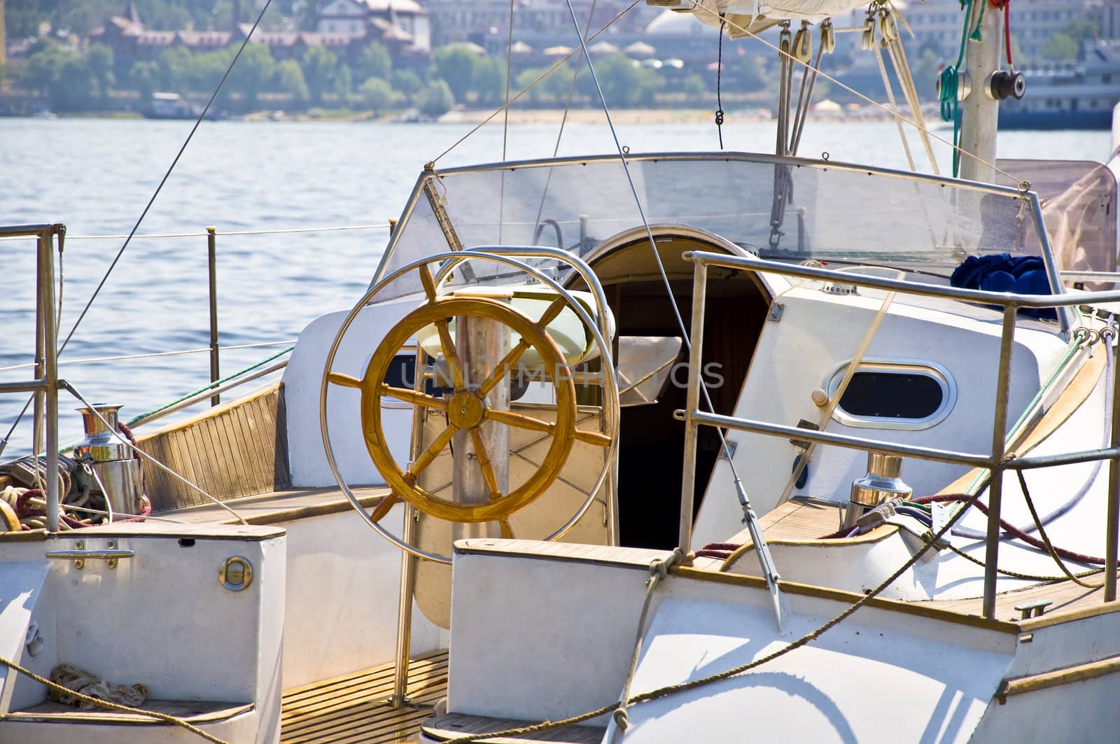 Foods yachts on the background of the port city in Russia. Summer. Close-up on the steering wheel of the ship.